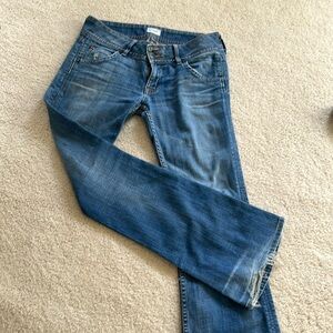 Hudson medium wash double button waist bootcut with some fraying on the bottom